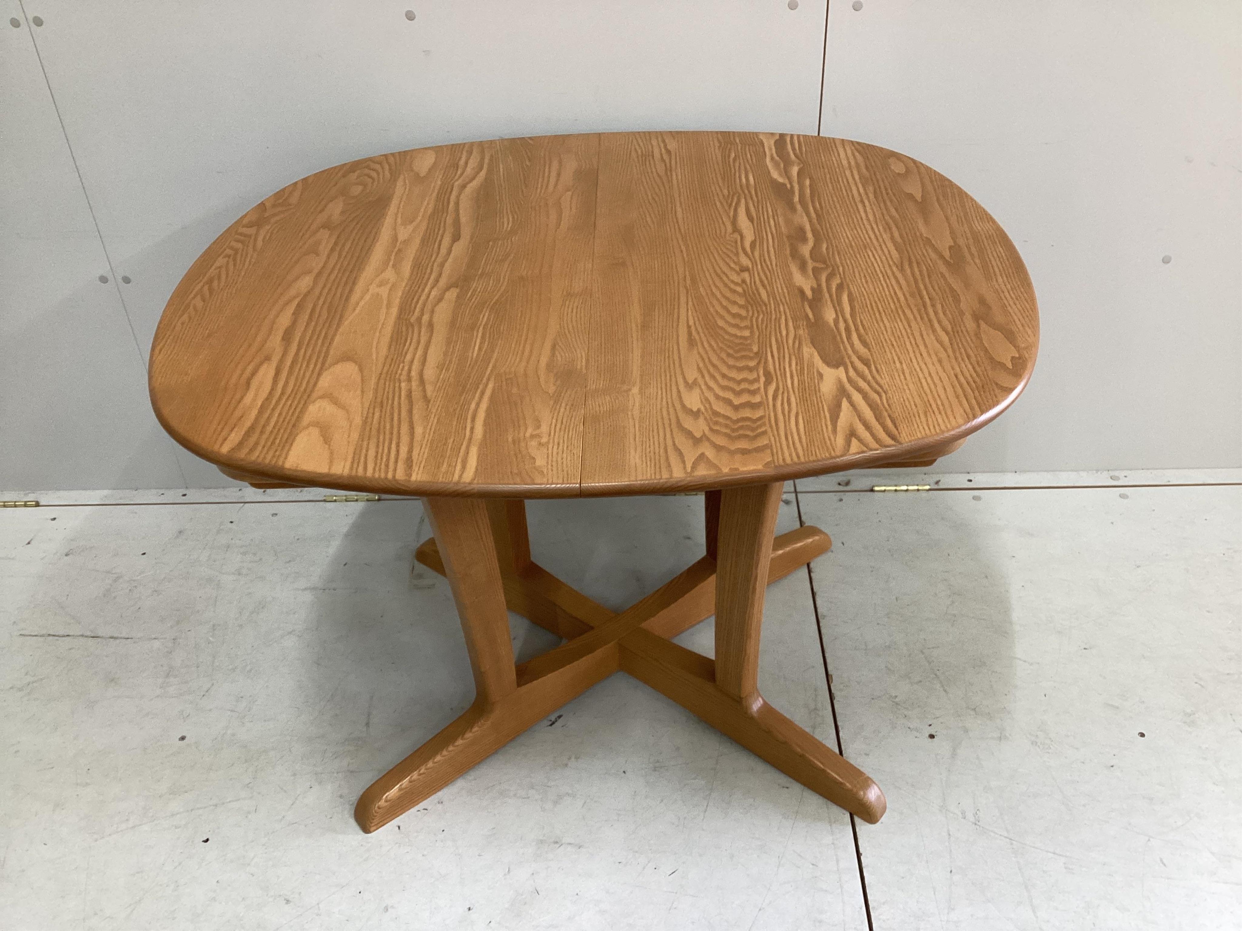 A modern Ercol elm extending dining table and six chairs, table 150cm extended, depth 89cm, height 73cm. Condition - good